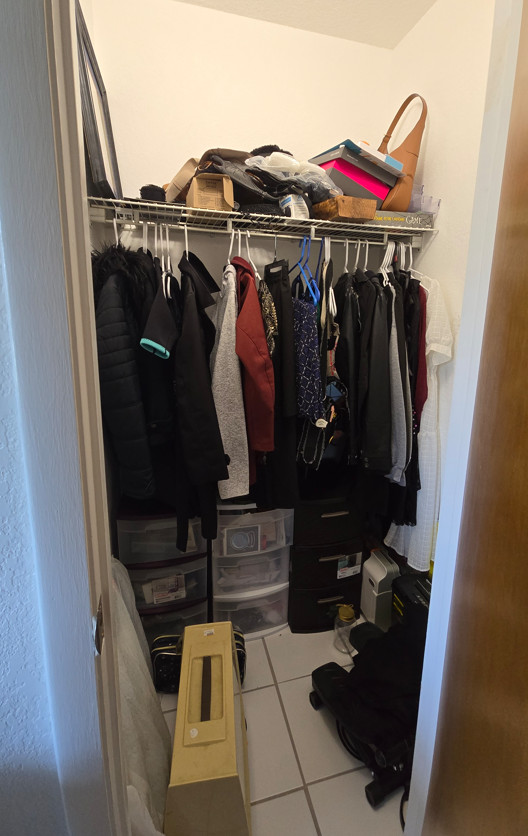 Closet before decluttering and organizing